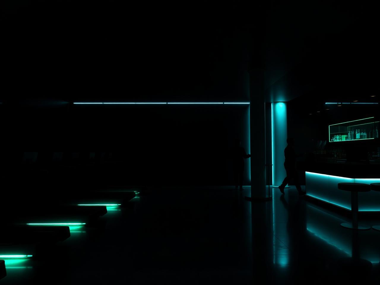 A moody upscale health club interior with cyan LED accents.